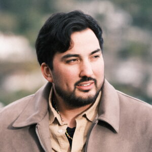 Photo of Felipe Contreras standing in front of a blurred backgroun